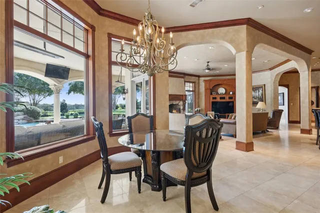 a view of a dining room with furniture wooden floor and chandelier