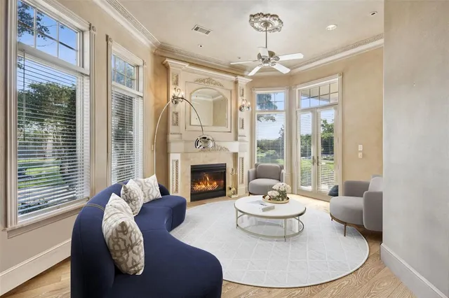 a living room with furniture a fireplace and a large window