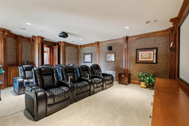 a living room with furniture a chandelier and a flat screen tv