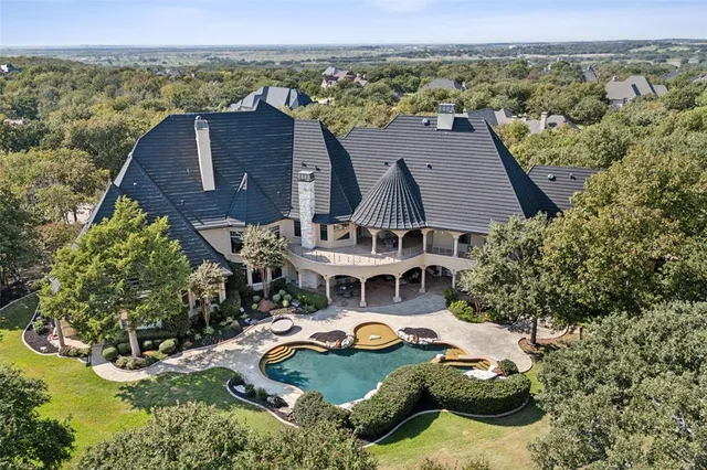 an aerial view of a house with outdoor space swimming pool and mountains