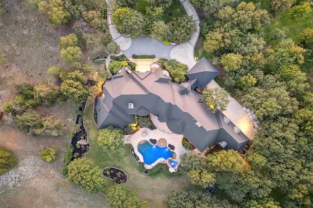 an aerial view of a house with a yard