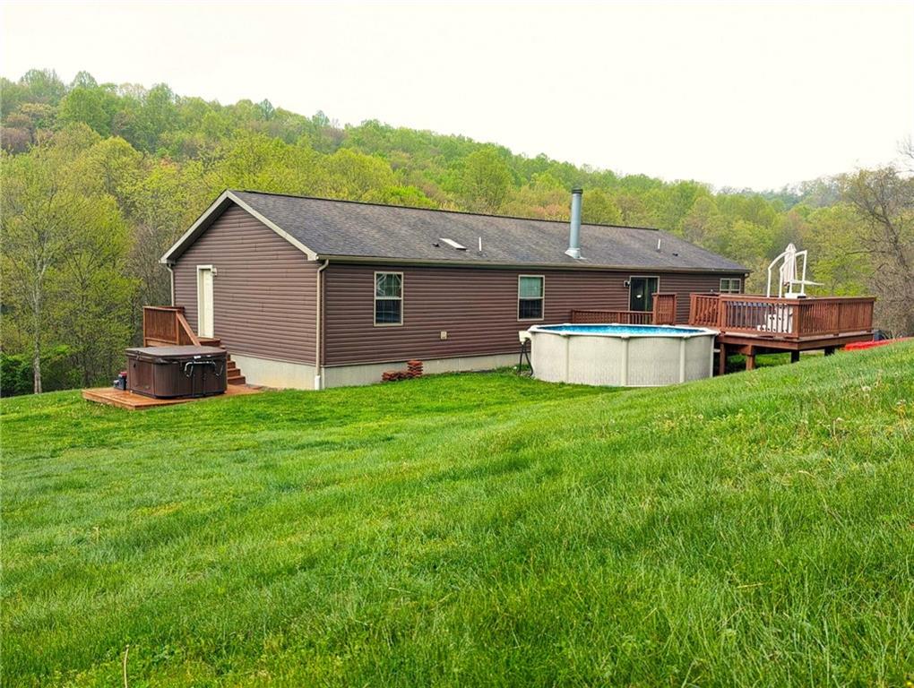 699 Dillie Road Sycamore, PA 15329 - Photo 3 of 21 a view of a house with backyard and a tree