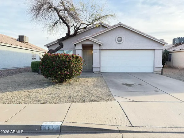 a view of a house with a yard and garage