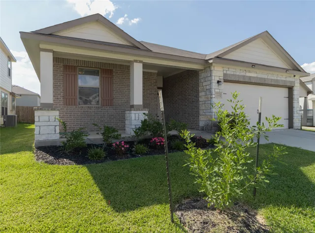 a front view of a house with a garden