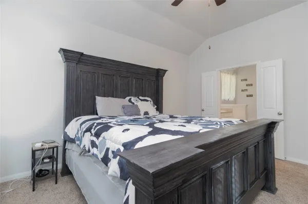 a bed sitting in a bedroom and table