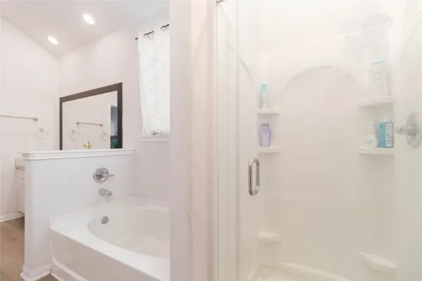 a bathroom with a bathtub and shower
