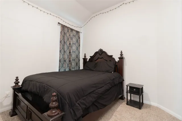 a bedroom with a bed and a chair