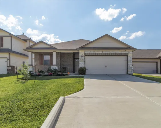 a front view of a house with a garden and plants
