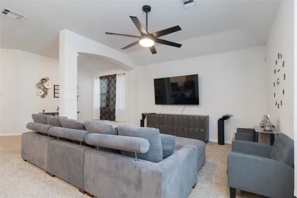 a living room with furniture and a flat screen tv