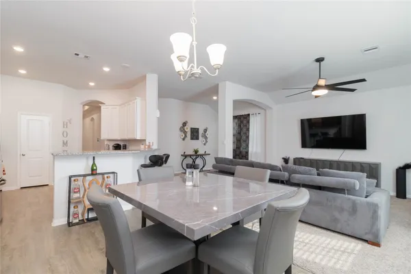 a view of a dining room with furniture and wooden floor