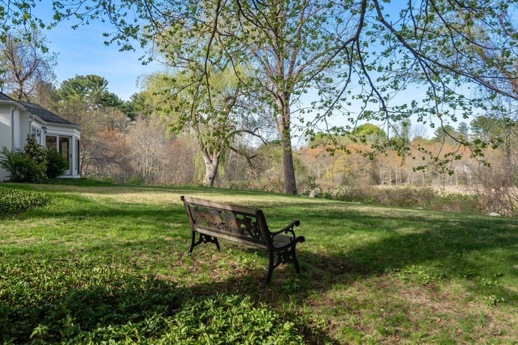 12 Granison Road Weston, MA 02493 - Photo 11 of 32 a backyard of a house with table and chairs