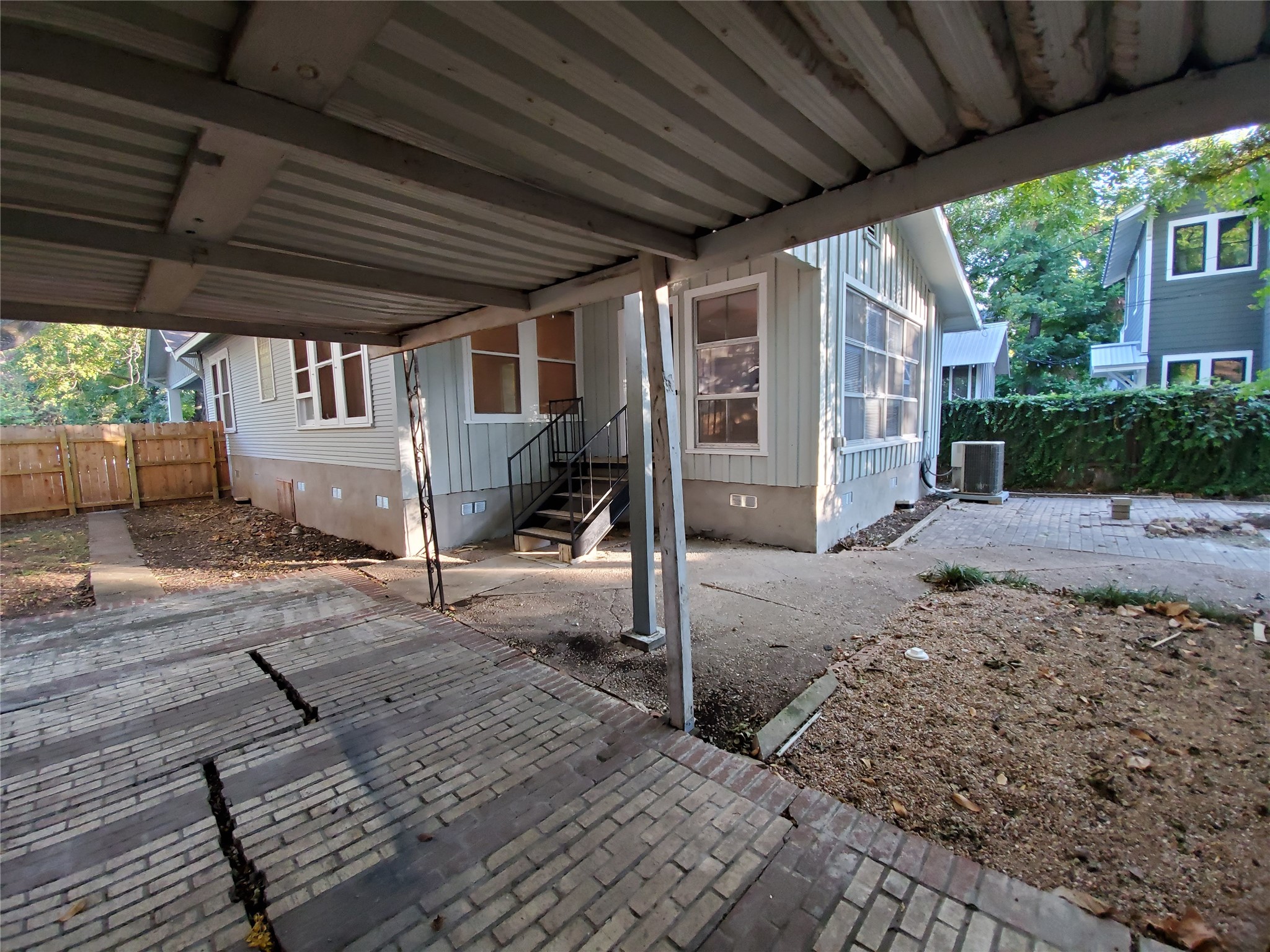 4113 Speedway Austin, TX 78751 - Photo 28 of 31 A covered carport opens to a paved patio area and structured siding exterior.