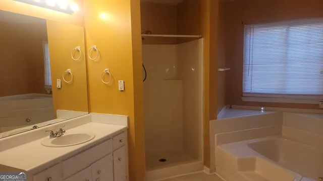a bathroom with a shower and a sink