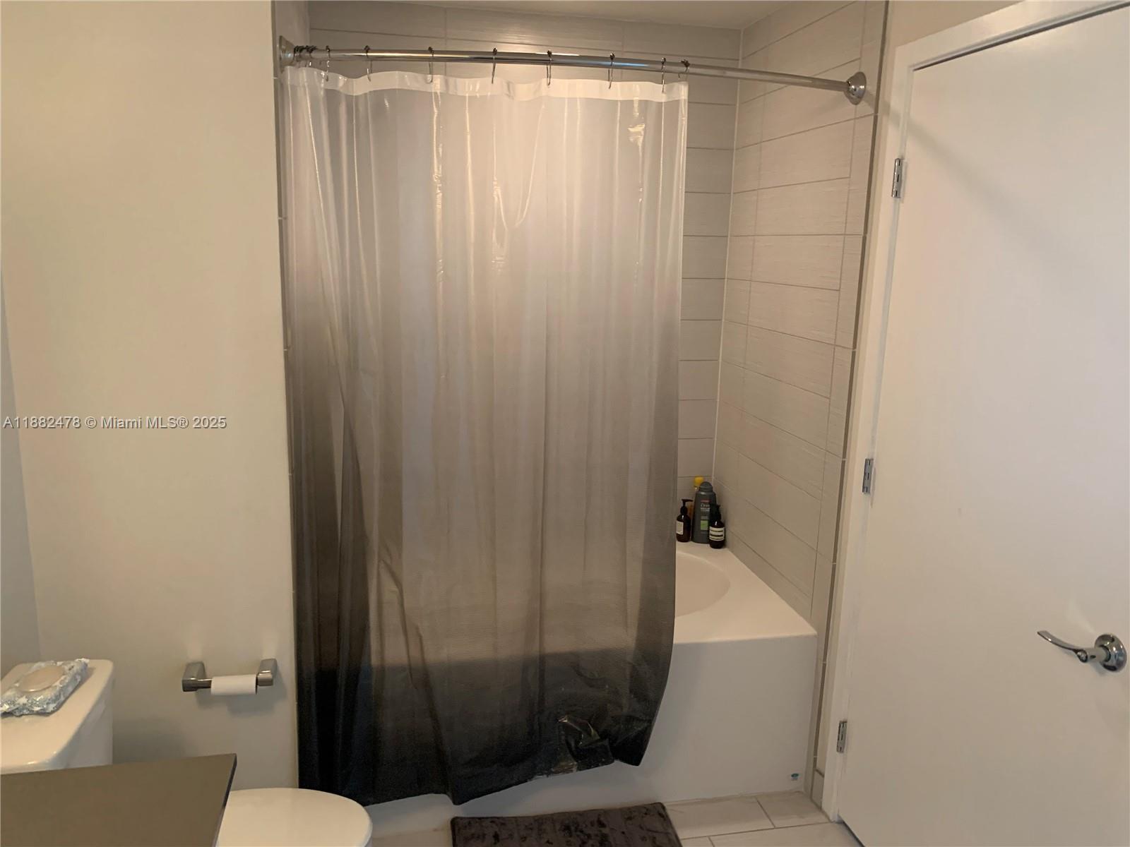 999 Southwest 1st Avenue, Unit 1703 Miami, FL 33130 - Photo 14 of 28 a bathroom with a shower and a toilet