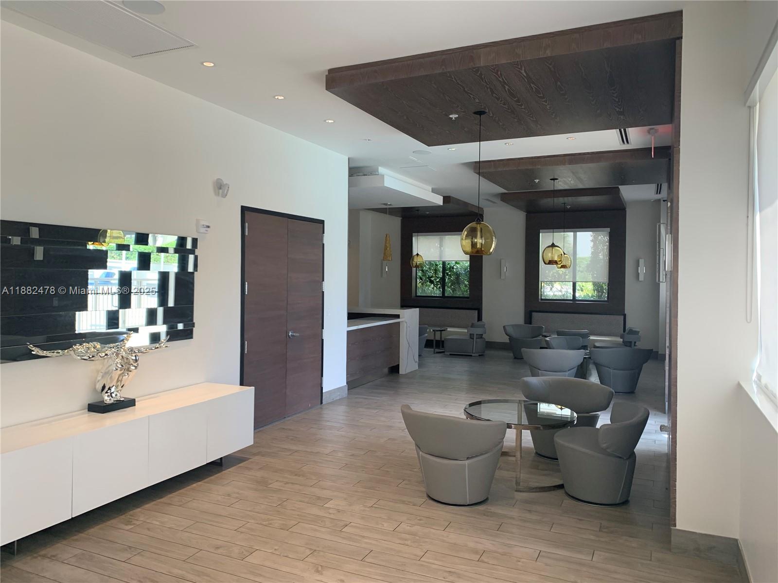 999 Southwest 1st Avenue, Unit 1703 Miami, FL 33130 - Photo 16 of 28 a large living room with furniture and a potted plant