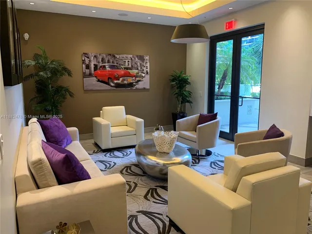 a living room with furniture and a floor to ceiling window