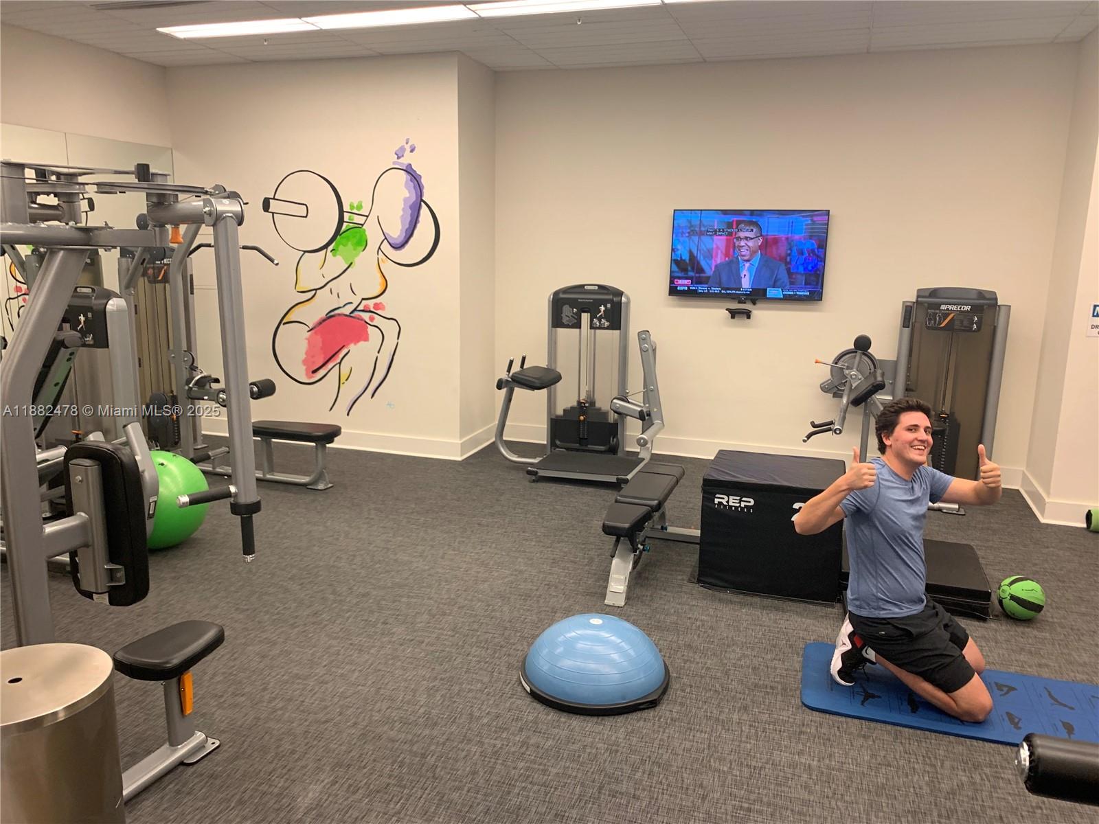 999 Southwest 1st Avenue, Unit 1703 Miami, FL 33130 - Photo 25 of 28 a room with gym equipment
