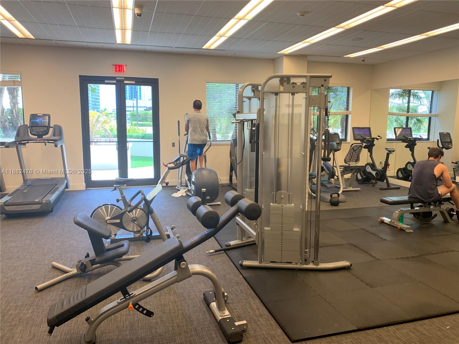 999 Southwest 1st Avenue, Unit 1703 Miami, FL 33130 - Photo 28 of 28 a room with gym equipment and a large window