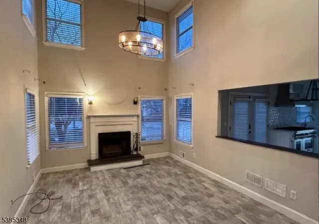 a view of a livingroom with an empty space and a fireplace