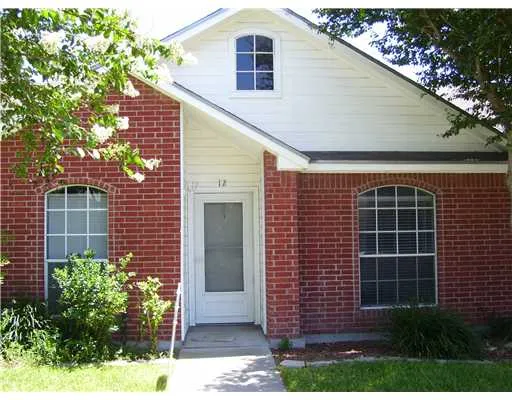 a front view of a house with plants