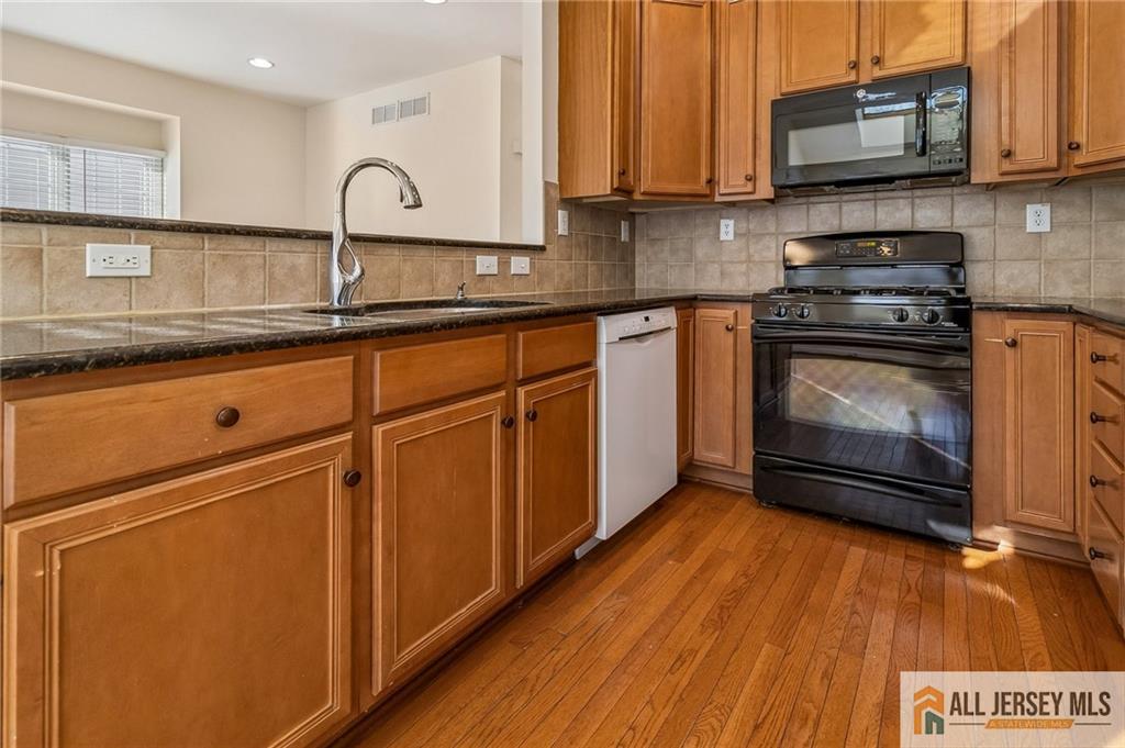 14 Caleb Lane Princeton, NJ 08540 - Photo 16 of 55 a kitchen with granite countertop wooden cabinets stainless steel appliances and a sink