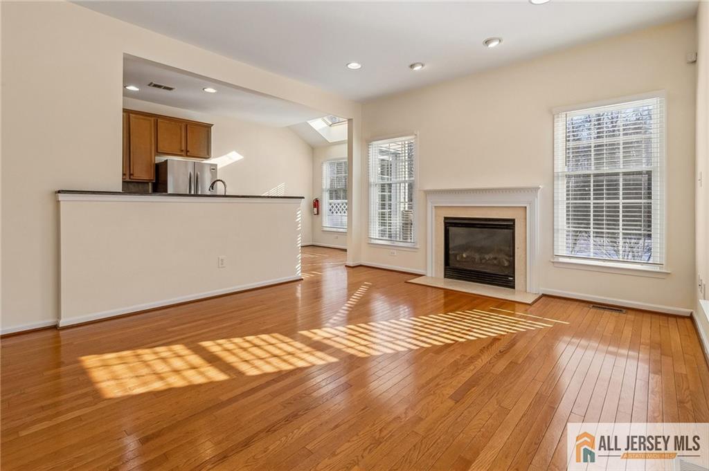 14 Caleb Lane Princeton, NJ 08540 - Photo 17 of 55 a view of kitchen and living room with wooden floor