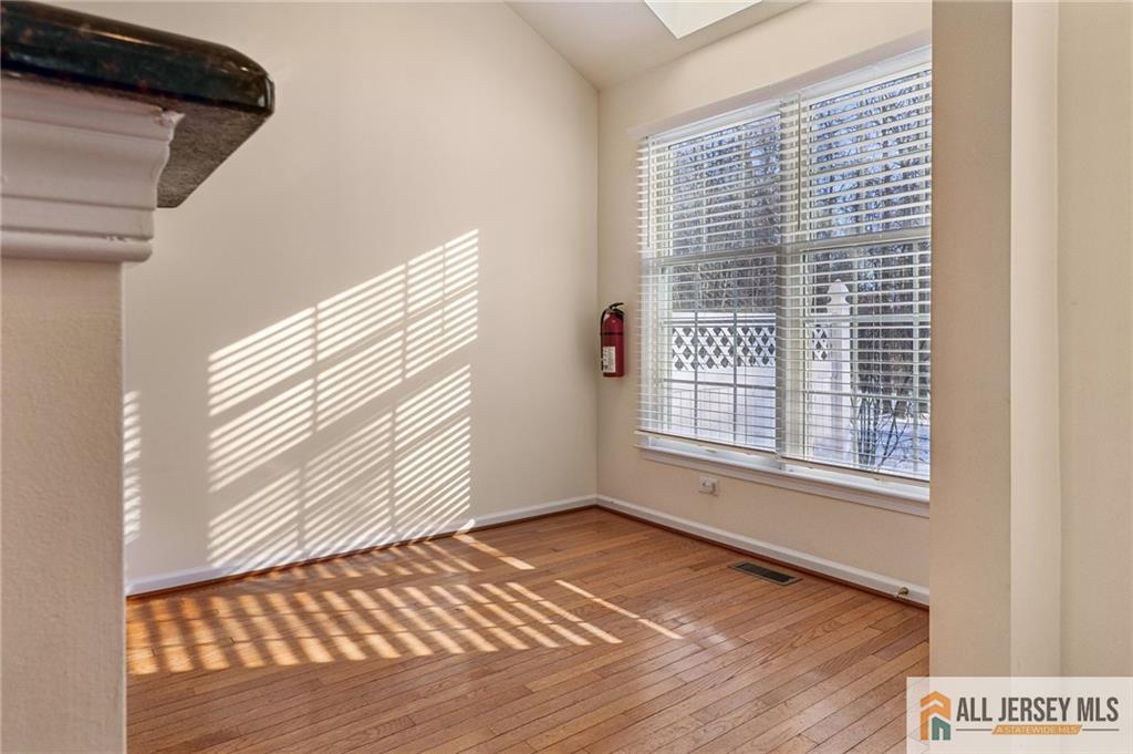 14 Caleb Lane Princeton, NJ 08540 - Photo 25 of 55 a view of an empty room with wooden floor and a window
