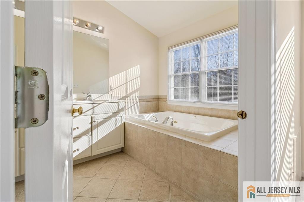 14 Caleb Lane Princeton, NJ 08540 - Photo 29 of 55 a bathroom with a tub sink and mirror