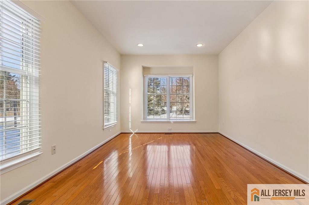 14 Caleb Lane Princeton, NJ 08540 - Photo 5 of 55 a view of an empty room with wooden floor and a window
