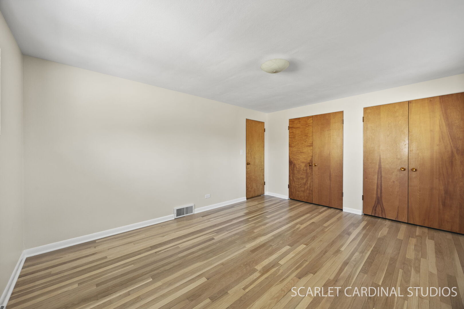 1210 Lawnmeadow Lane Naperville, IL 60540 - Photo 19 of 37 a view of an empty room with wooden floor and a window