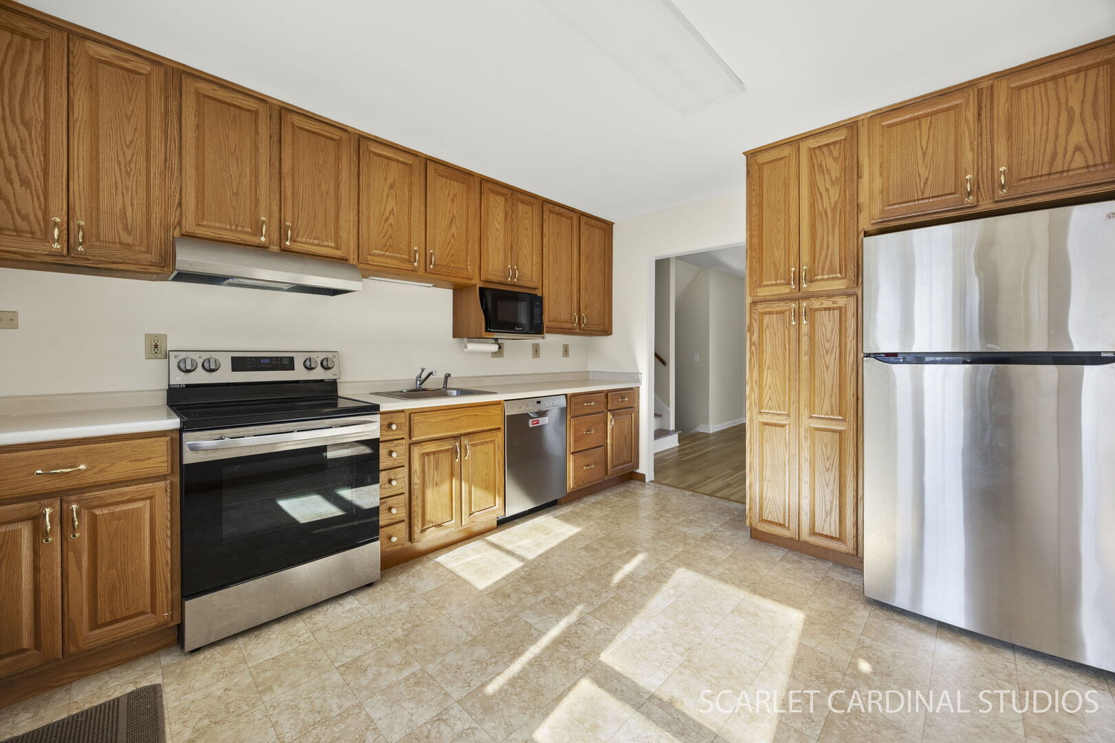 1210 Lawnmeadow Lane Naperville, IL 60540 - Photo 8 of 37 a kitchen with a refrigerator sink stove and cabinets