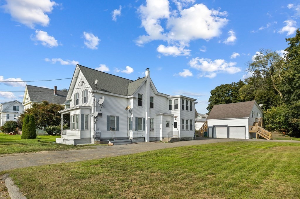 253 Mammoth Road Lowell, MA 01854 - Photo 1 of 42 a view of a big house with a big yard plants and large trees