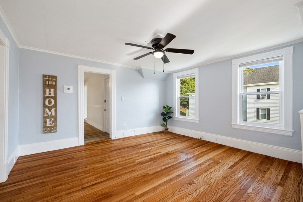 253 Mammoth Road Lowell, MA 01854 - Photo 14 of 42 a view of empty room with wooden floor and fan