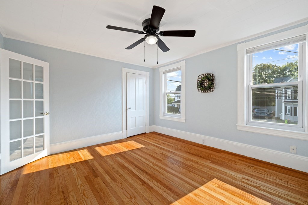 253 Mammoth Road Lowell, MA 01854 - Photo 16 of 42 a view of empty room with wooden floor and fan