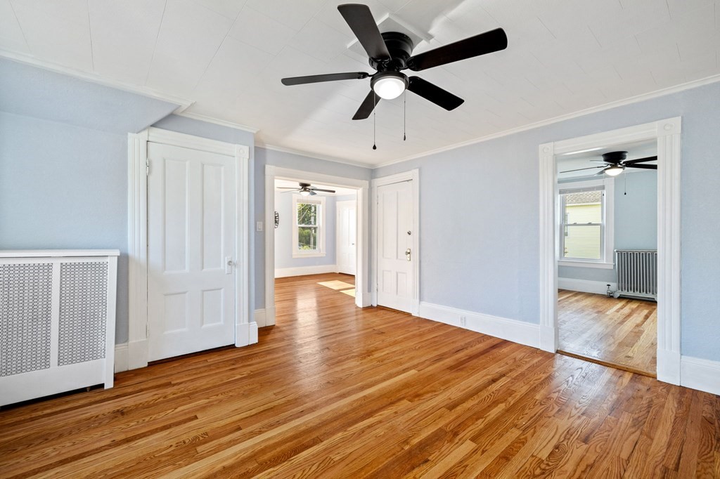 253 Mammoth Road Lowell, MA 01854 - Photo 21 of 42 wooden floor in an empty room with a window