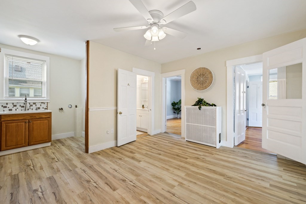 253 Mammoth Road Lowell, MA 01854 - Photo 29 of 42 a view of a kitchen cabinets and wooden floor