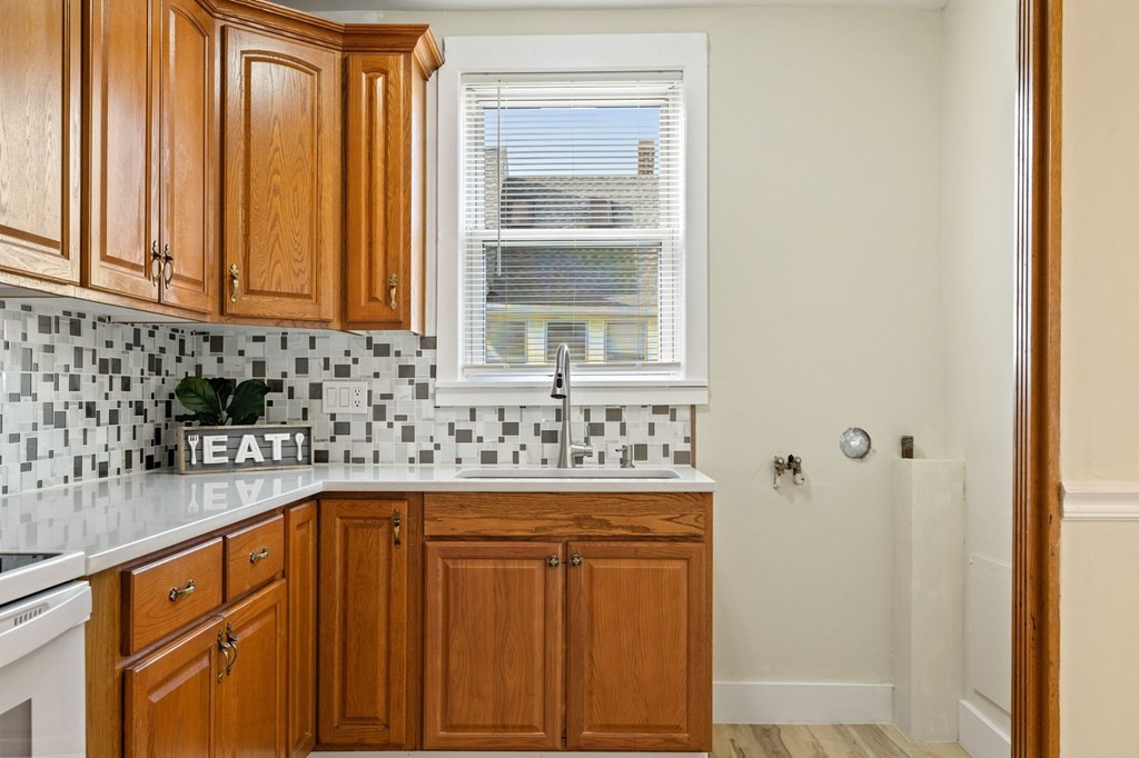 253 Mammoth Road Lowell, MA 01854 - Photo 30 of 42 a kitchen with stainless steel appliances granite countertop a sink and a window