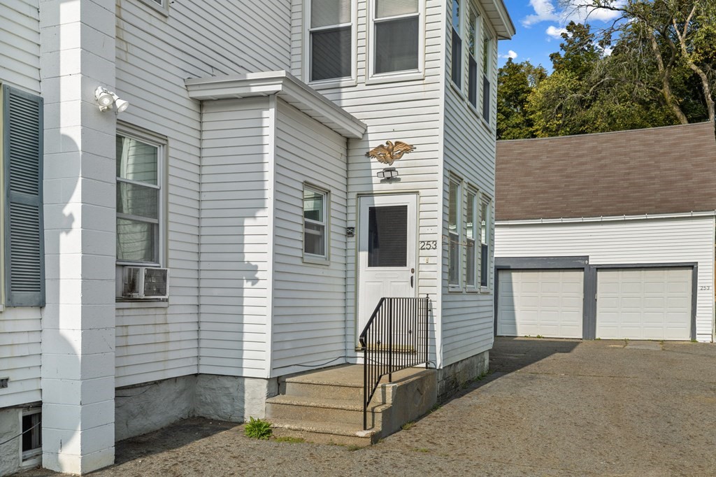 253 Mammoth Road Lowell, MA 01854 - Photo 3 of 42 a view of a house with backyard and trees
