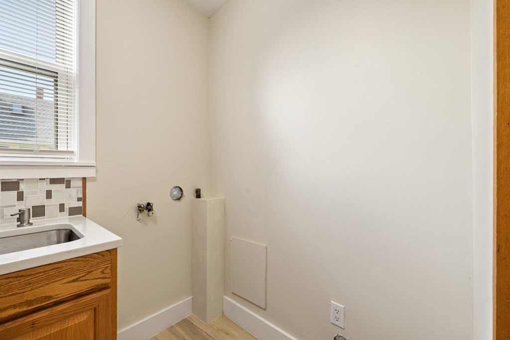 253 Mammoth Road Lowell, MA 01854 - Photo 34 of 42 a bathroom with a sink a toilet and shower