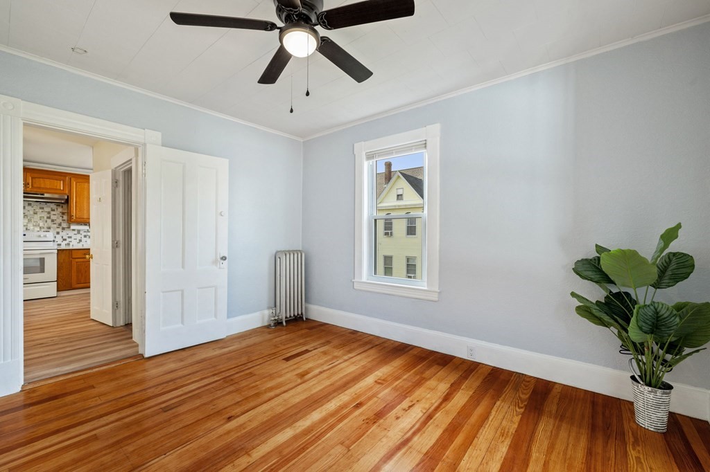 253 Mammoth Road Lowell, MA 01854 - Photo 38 of 42 a view of empty room with wooden floor and fan