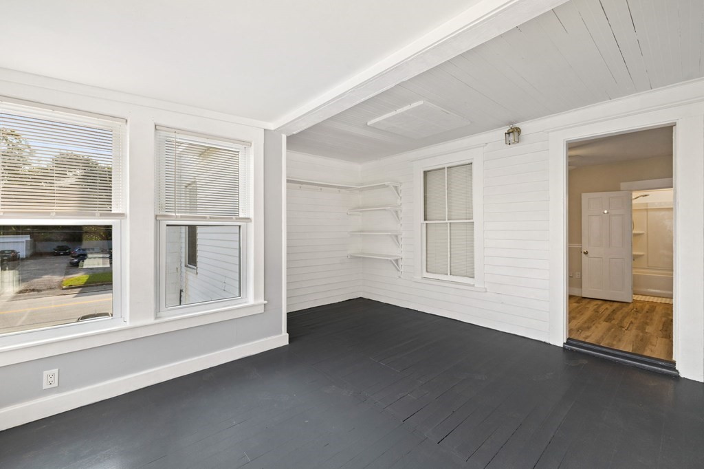 253 Mammoth Road Lowell, MA 01854 - Photo 42 of 42 an empty room with wooden floor and windows