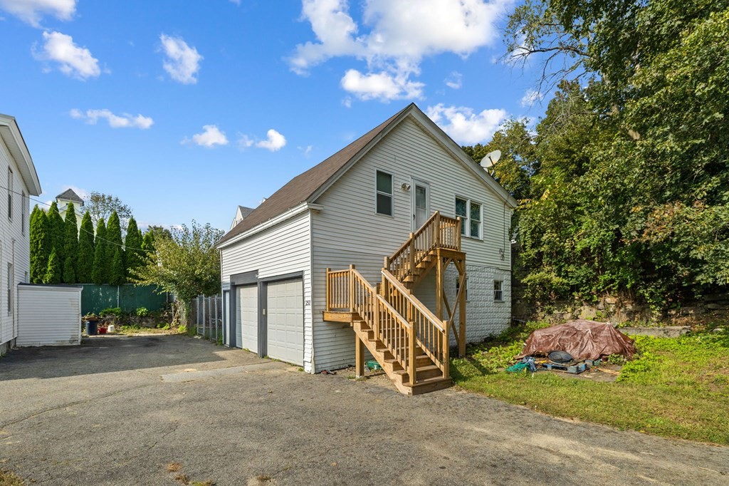 253 Mammoth Road Lowell, MA 01854 - Photo 6 of 42 a front view of a house with a yard