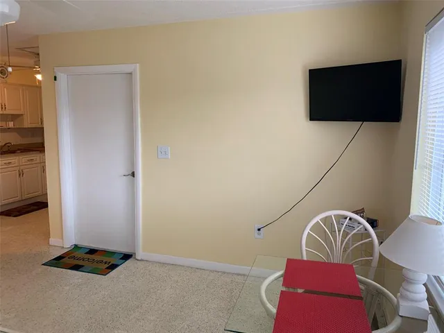a view of a livingroom with furniture and flat screen tv