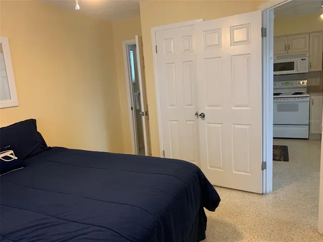 a bedroom with a bed and cabinets