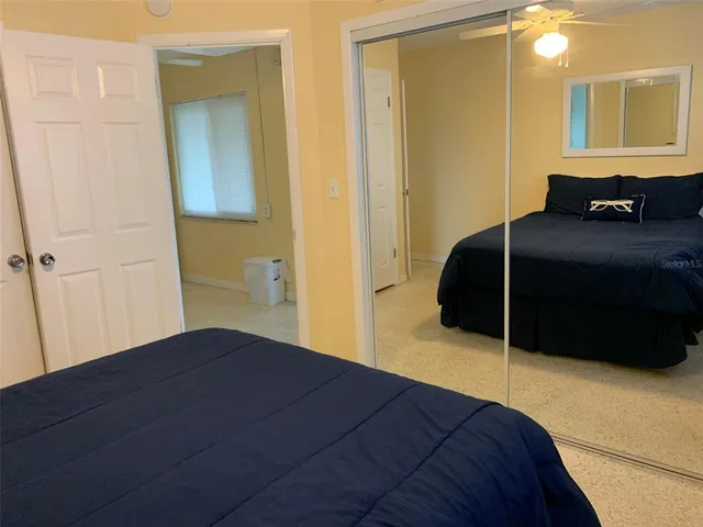 a bedroom with a bed and a mirror