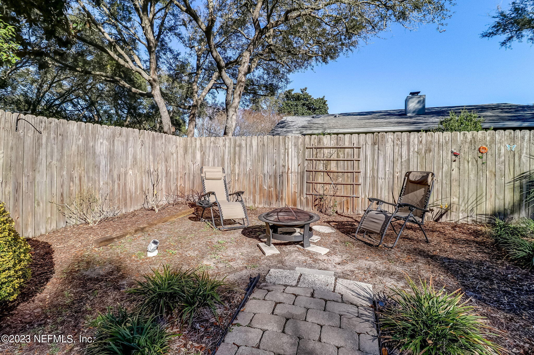 2212 Will Hardee Road Fernandina Beach, FL 32034 - Photo 23 of 24 a backyard of a house with table and chairs