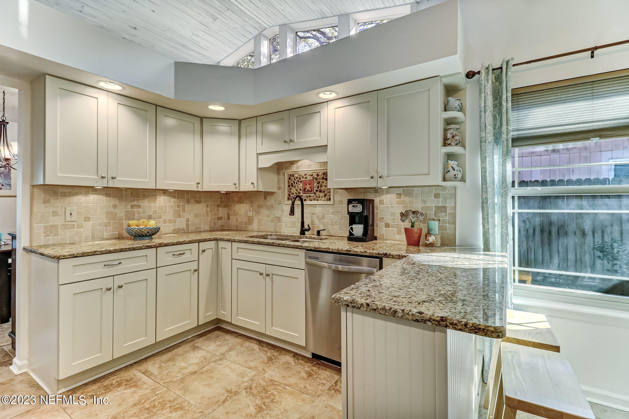 2212 Will Hardee Road Fernandina Beach, FL 32034 - Photo 10 of 24 a kitchen with kitchen island granite countertop a sink and white cabinets