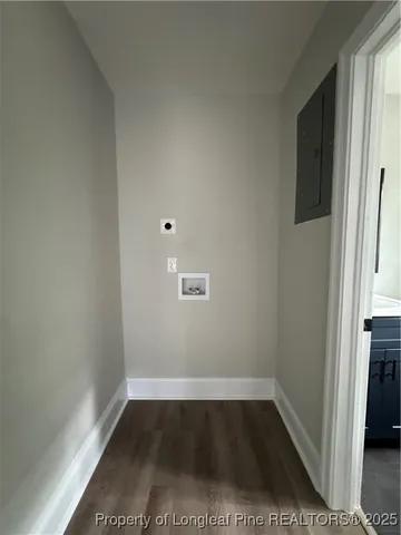 a view of a room with wooden floor and a window