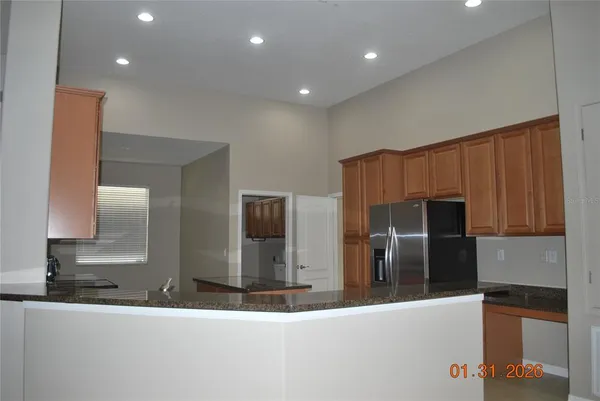a kitchen with stainless steel appliances granite countertop a refrigerator and a sink