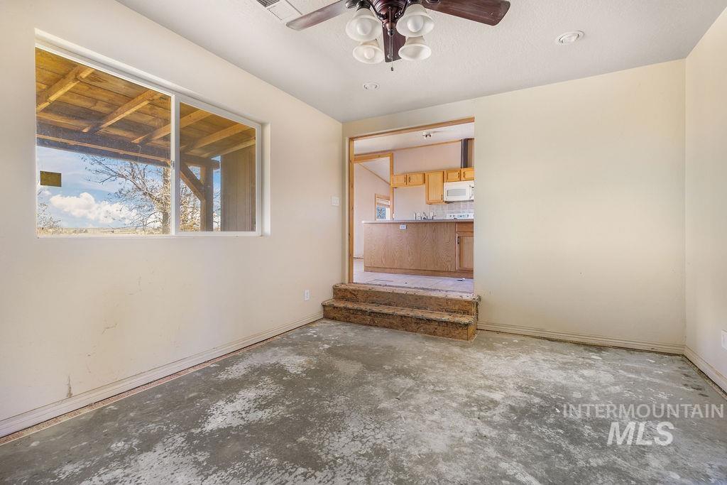 7370 Sagebrush Lane Caldwell, ID 83607 - Photo 16 of 40 Spare room with ceiling fan and unfinished concrete floors